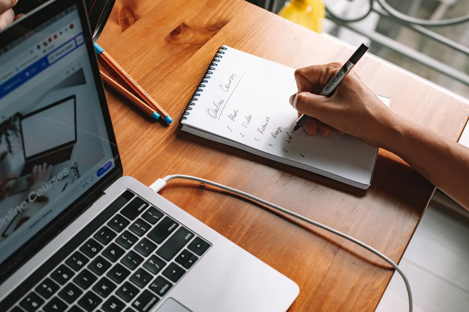 Hiring manager drafting a job description checklist by hand