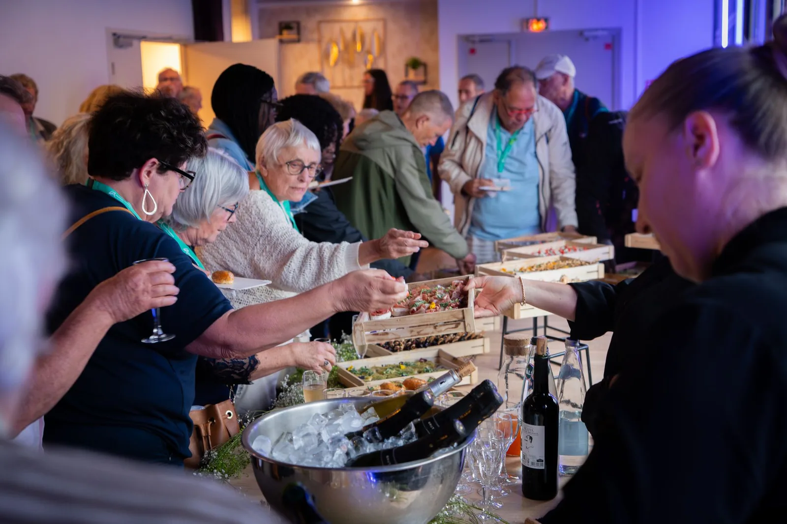 A small open group of attendees in conversation at a conference reception