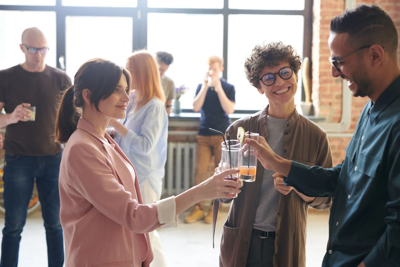 Professionals talking in small groups at an evening networking event