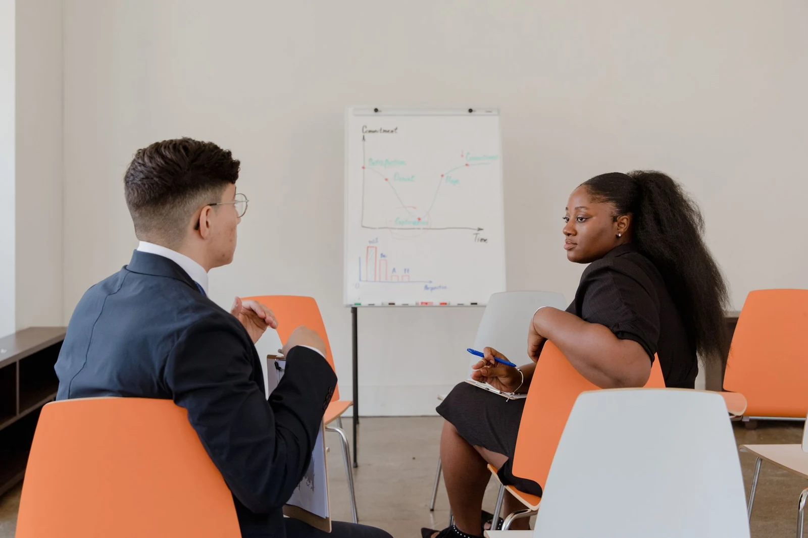Two people in conversation across a meeting table