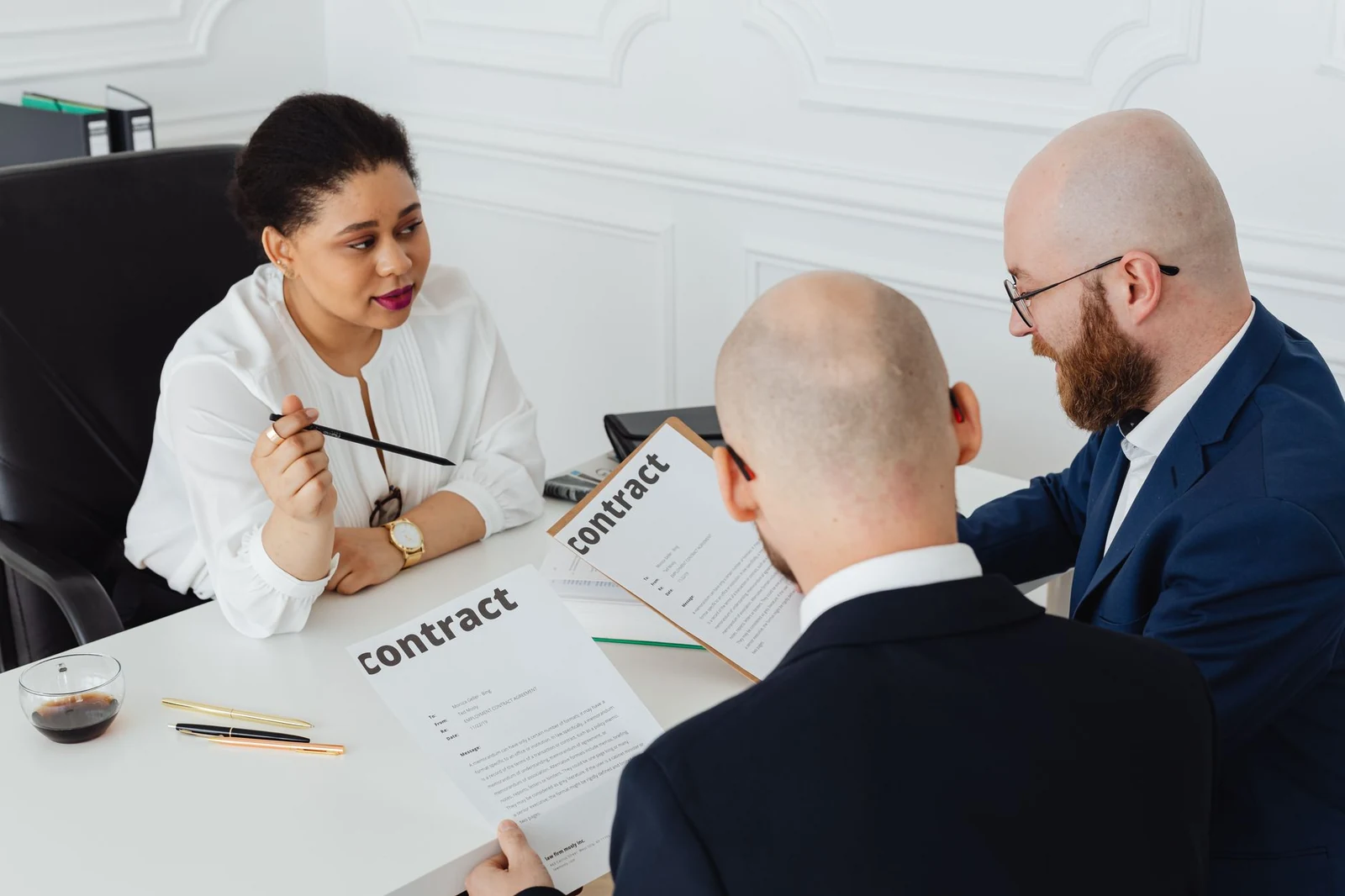 Two professionals reviewing a contract at a desk