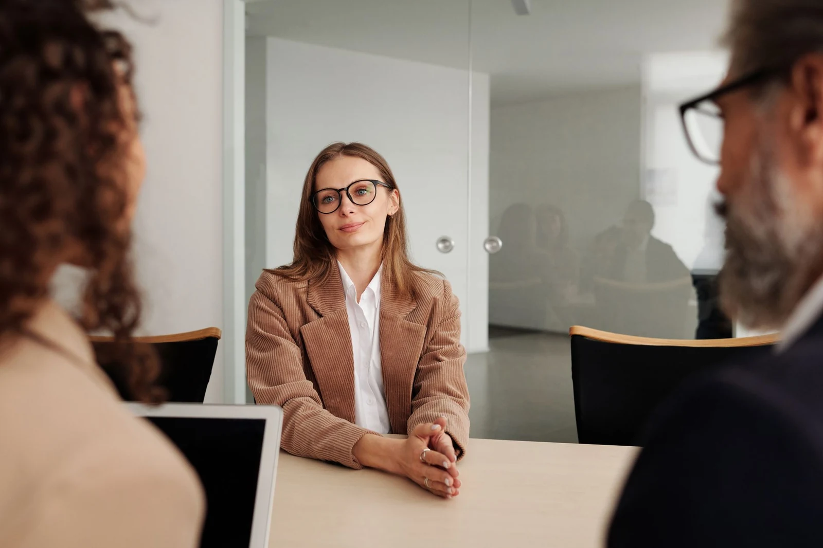 A hiring panel interviewing a candidate in a conference room