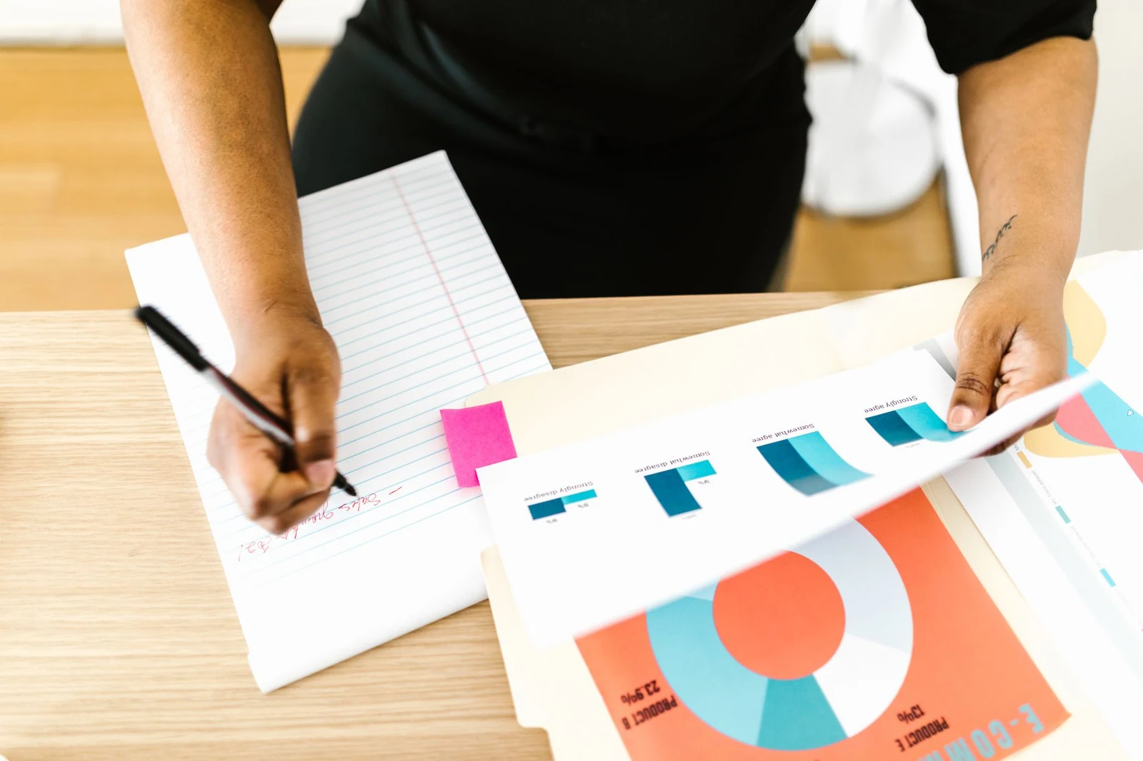 Person comparing figures on a printed chart