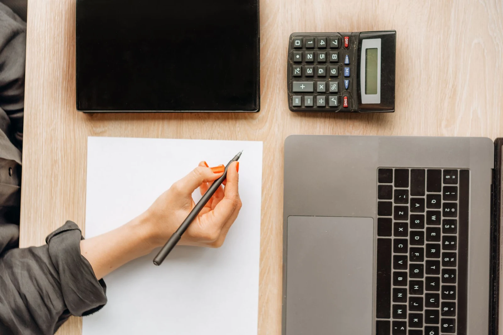 Calculator and handwritten figures adding up the cost of a hire that did not work out