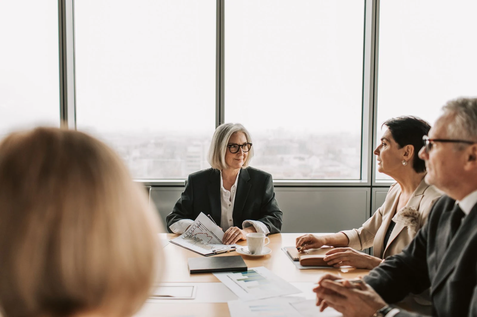 A small group of executives in a private boardroom meeting