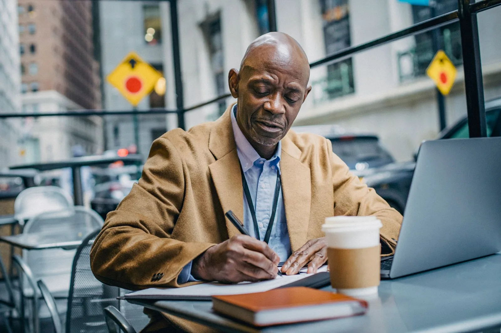 A small business owner drafting a job description on a laptop