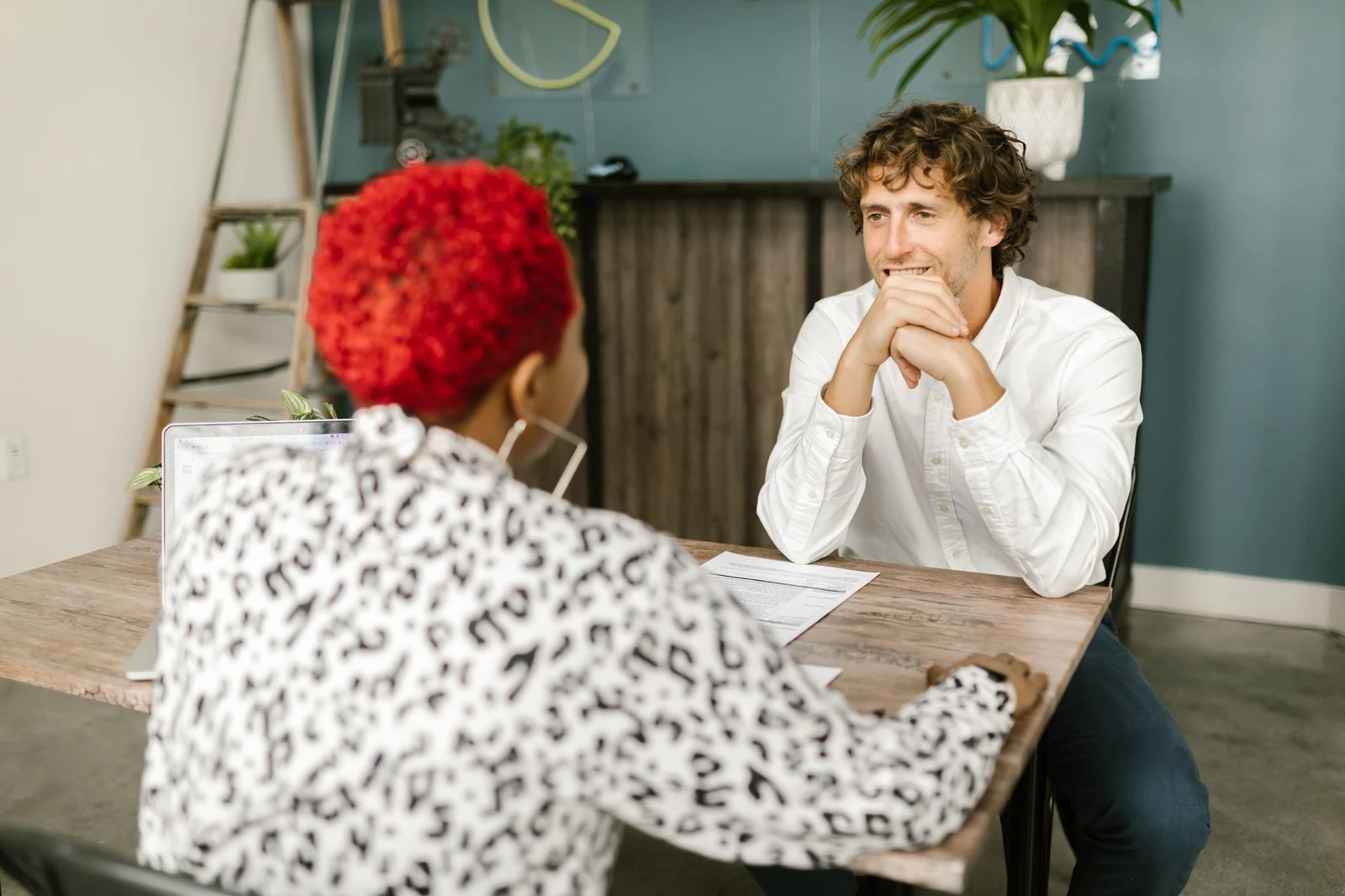 An interviewer and a candidate talking across a table