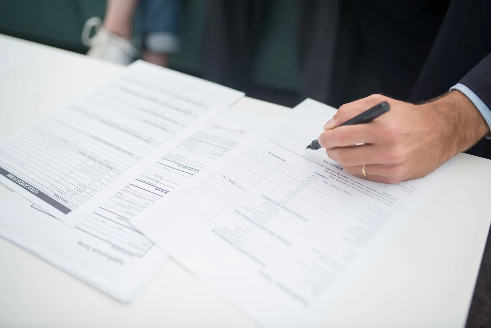 Employment forms being completed with a pen