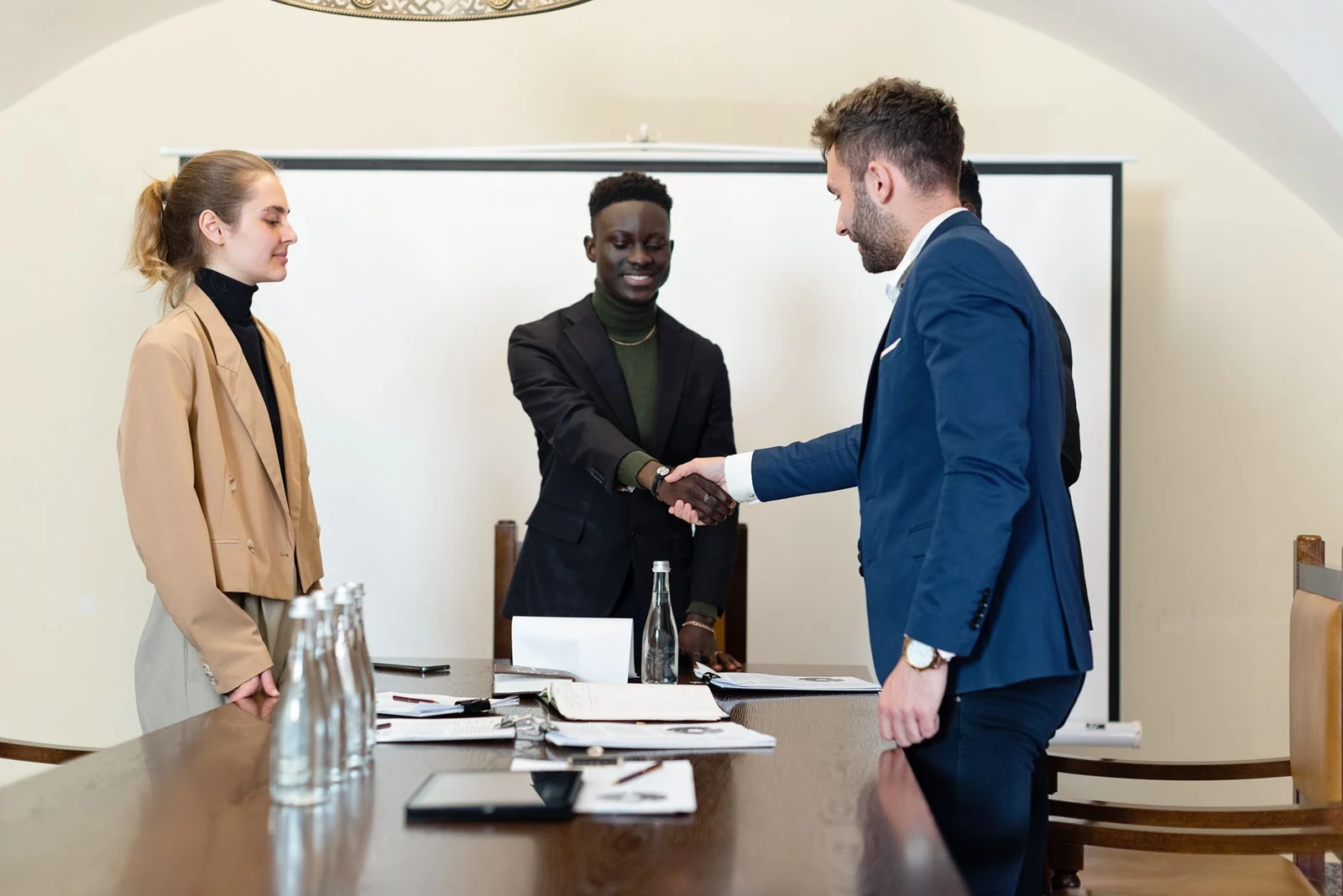 Employer and new hire shaking hands after an accepted offer